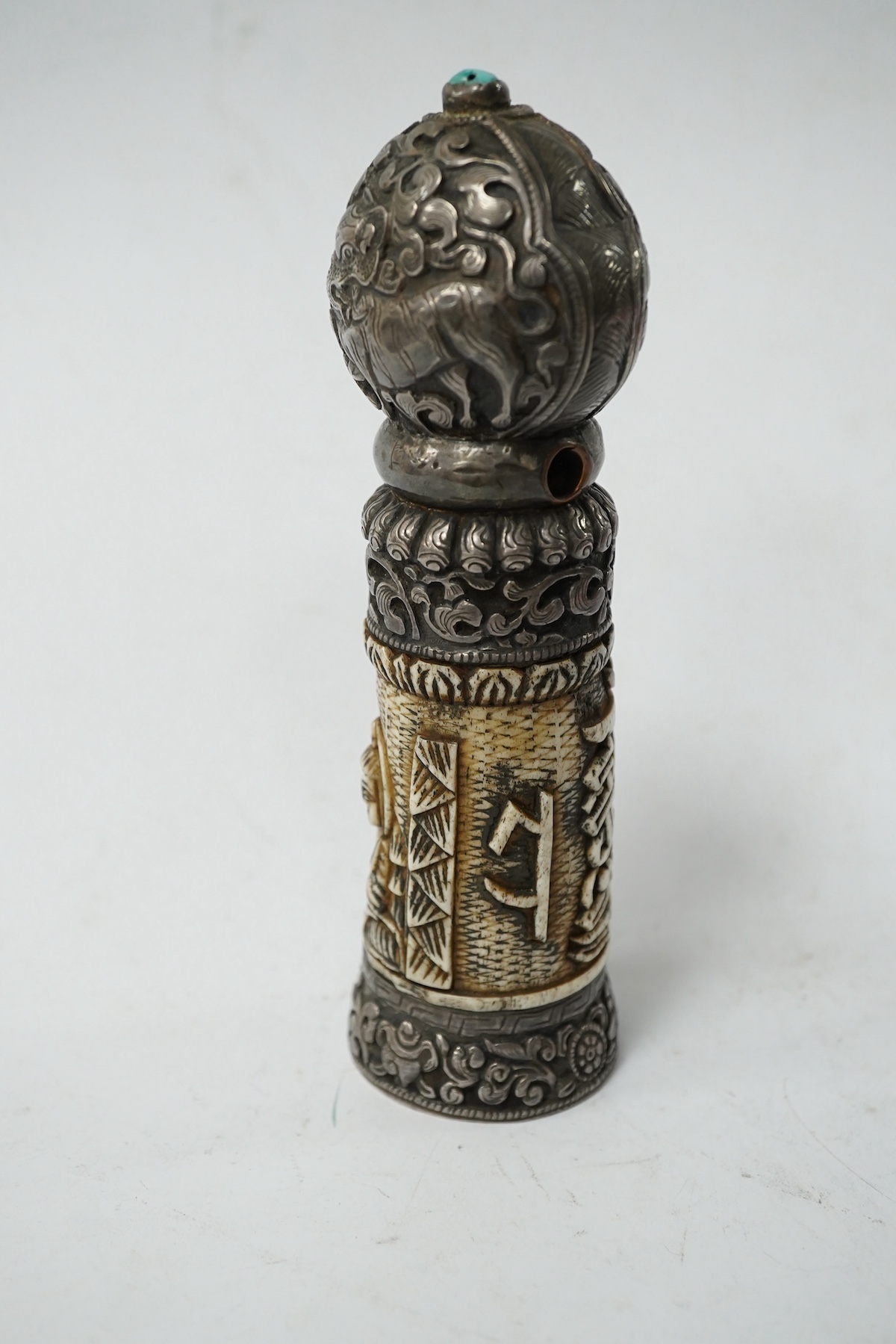 A Tibetan bone and repousse work seal, late 19th/early 20th century, 15cm high. Condition - fair